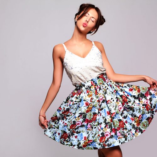 Portrait of beautiful cute brunette woman model in casual summer jeans clothes with no makeup with horns hairstyle  isolated on gray. Giving air kiss Portrait of beautiful cute brunette woman model in casual summer jeans clothes with no makeup with horns hairstyle  isolated on gray. Giving air kiss